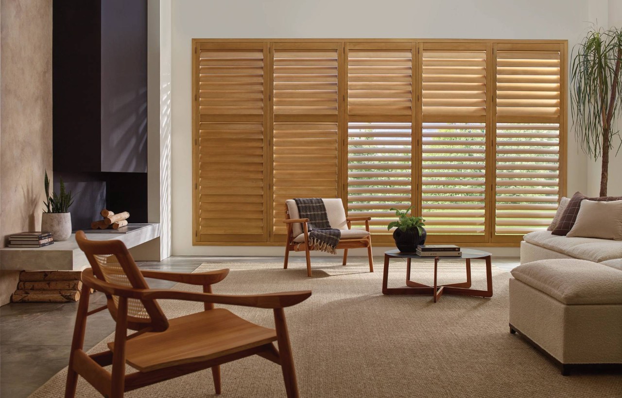 Home living room with large windows outfitted with Hunter Douglas Heritance® Hardwood Shutters at Dale's AAA Blind Factory near Naples, FL