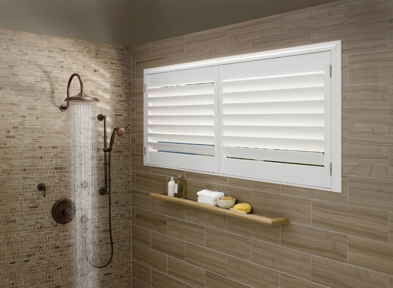 White interior Hunter Douglas Palm Beach™ Polysatin™ Vinyl Shutters in a modern and chic shower at Dale's AAA Blind Factory near Naples, (FL)