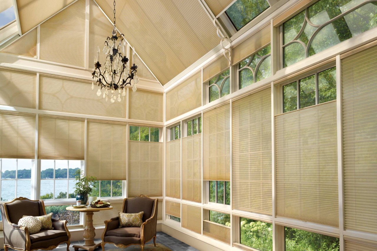 Hunter Douglas Duette® Cellular Shades as skylight shades in a sunroom overlooking a body of water near Naples, FL